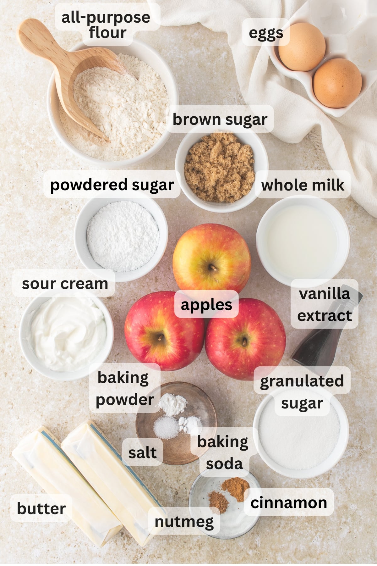 Ingredients needed to make Apple Spice Cake arranged in bowls on a table.