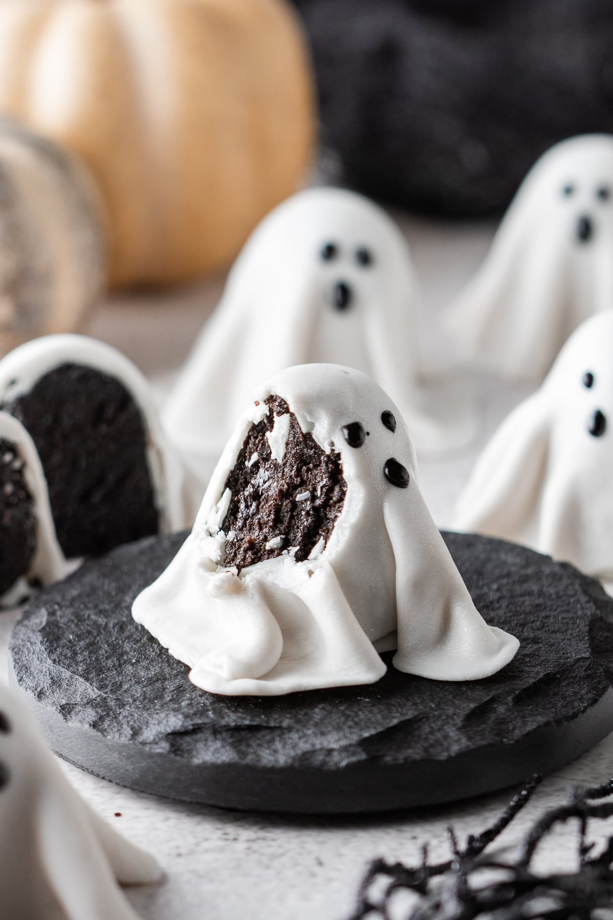 Finished ghosts on table with one in front missing a bite.