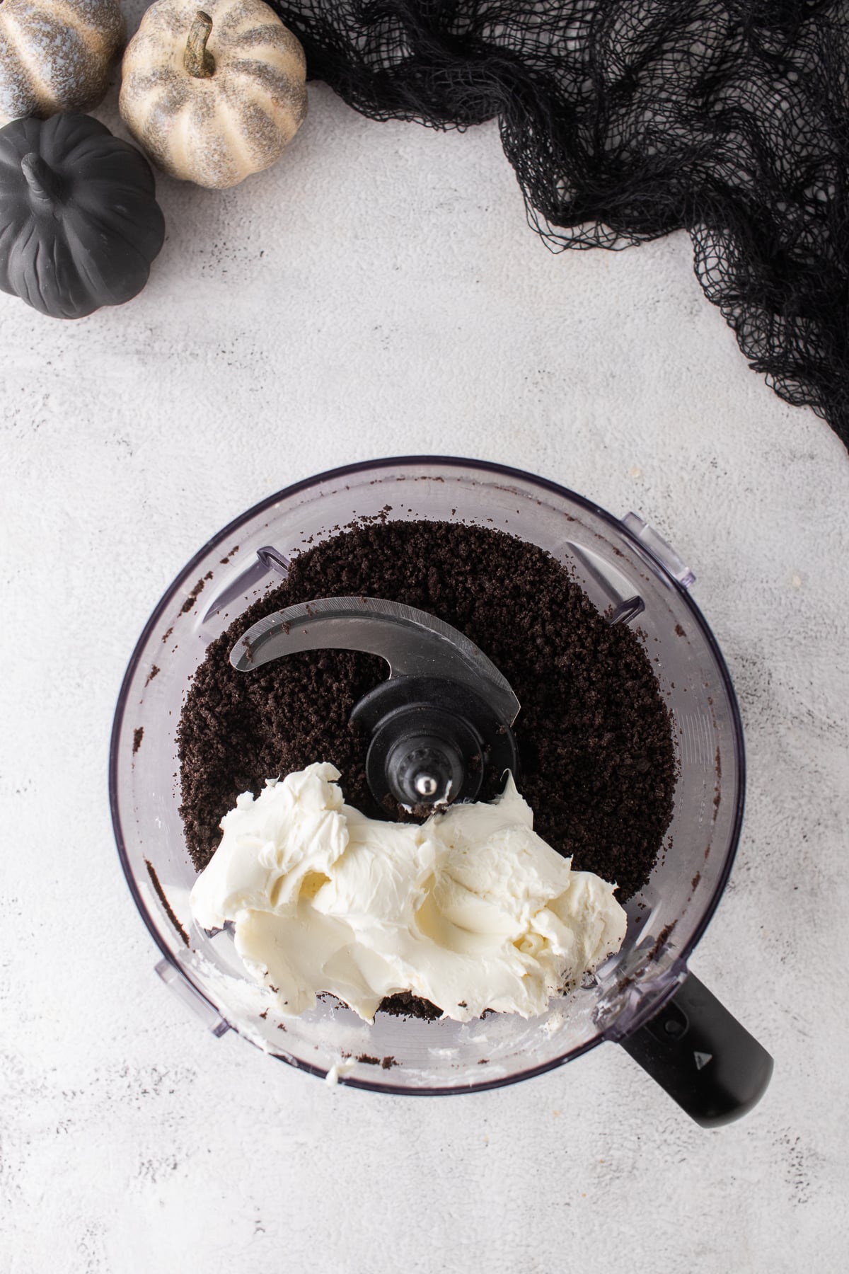Oreo cookies and cream cheese in a food processor for making truffle filling.