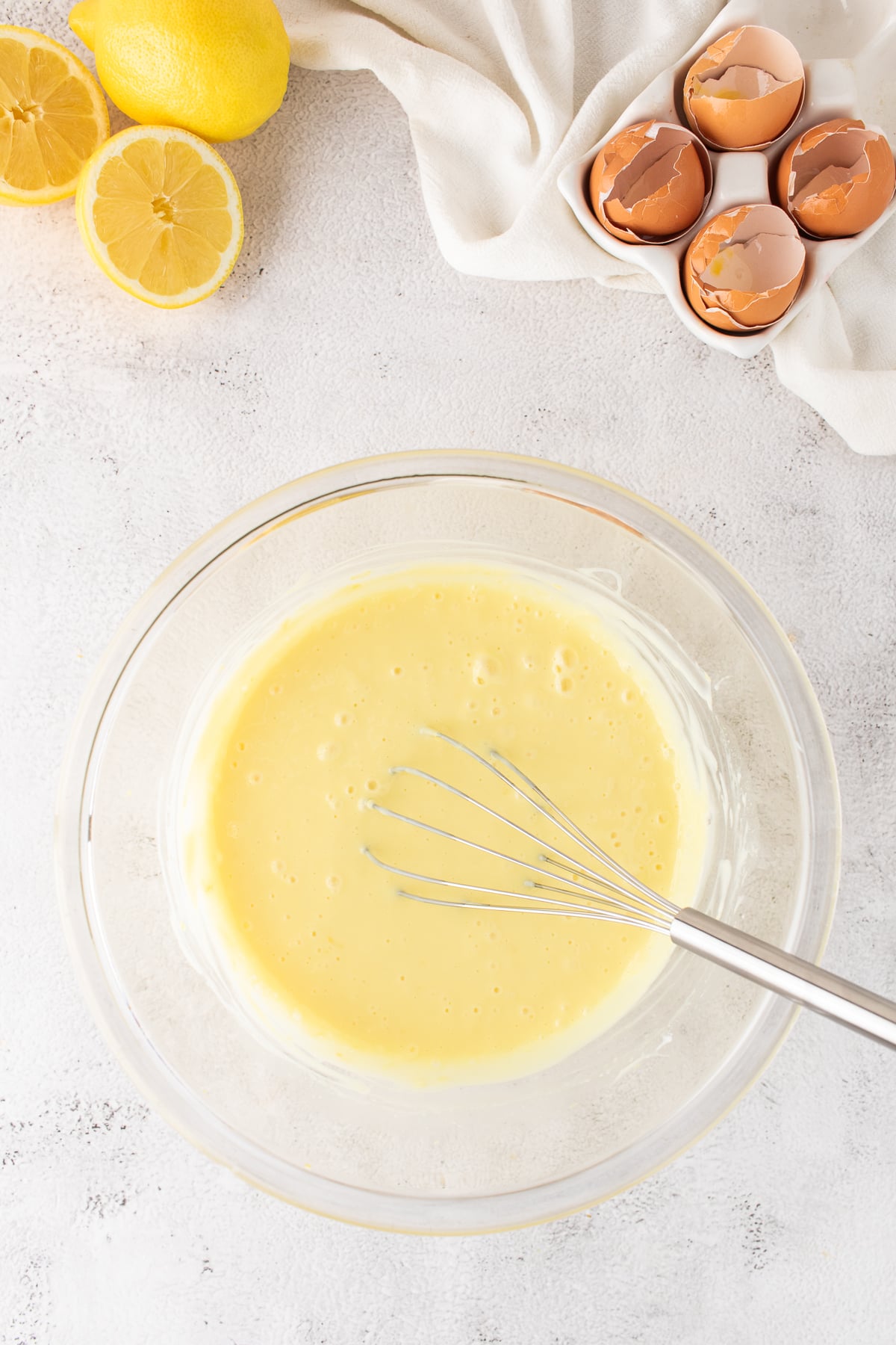 Creamy lemon filling ready to pour over a warm shortbread cookie crust.