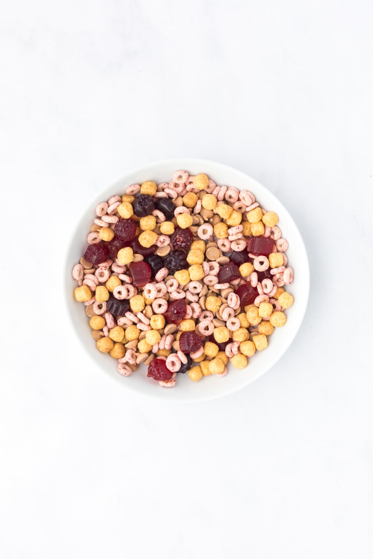 Trail Mix ingredients tossed together in a mixing bowl.