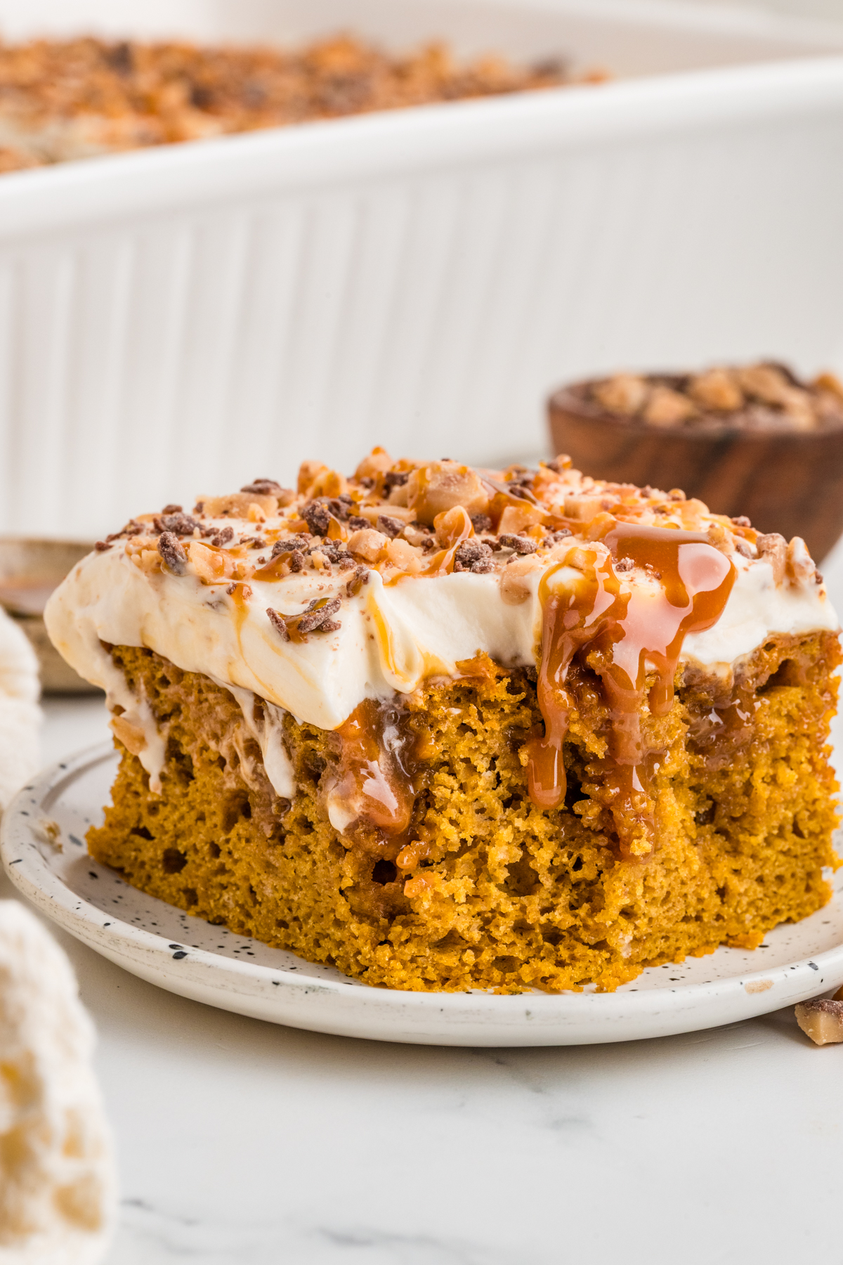 A slice of cake on a plate missing a bite.