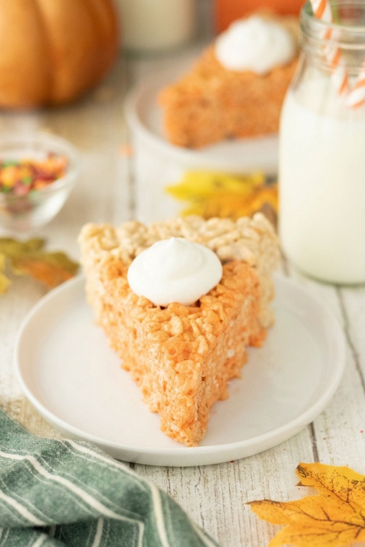 A slice of pie with a dollop of whipped cream on a plate.