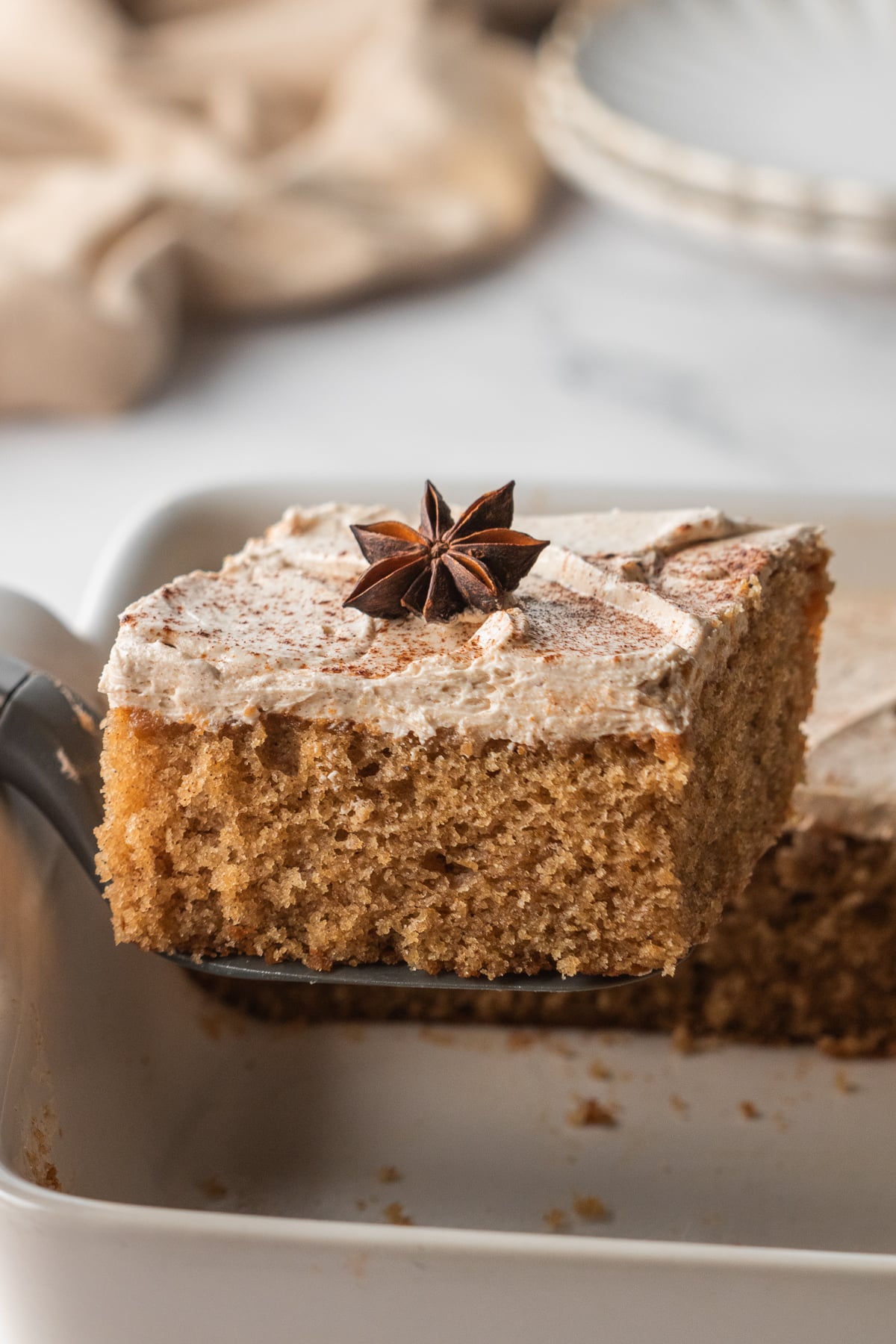 A slice of cake lifted out of the 9x13-inch pan.