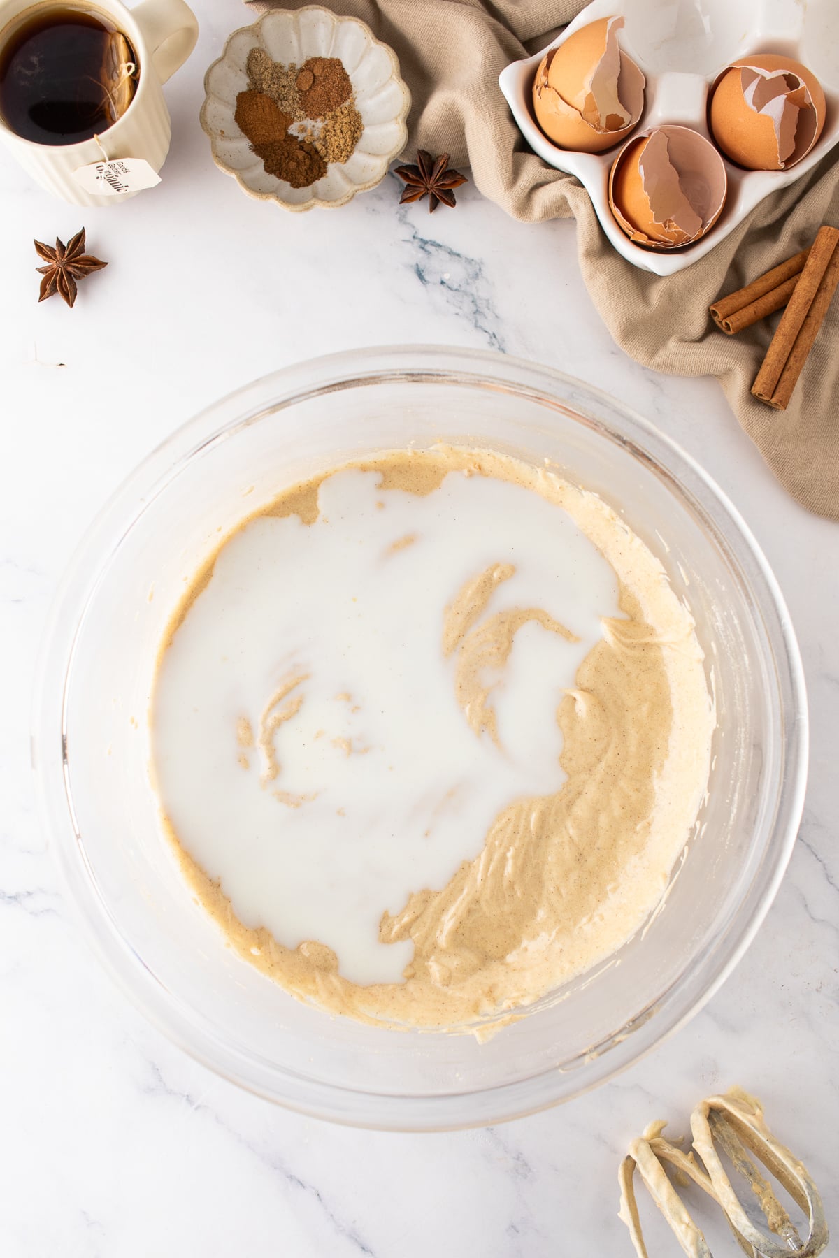 Finished chai cake batter in a mixing bowl with flour mixture added.