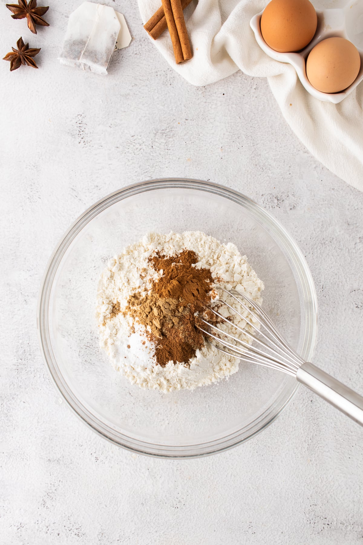 Dry ingredients in a bowl with a whisk.