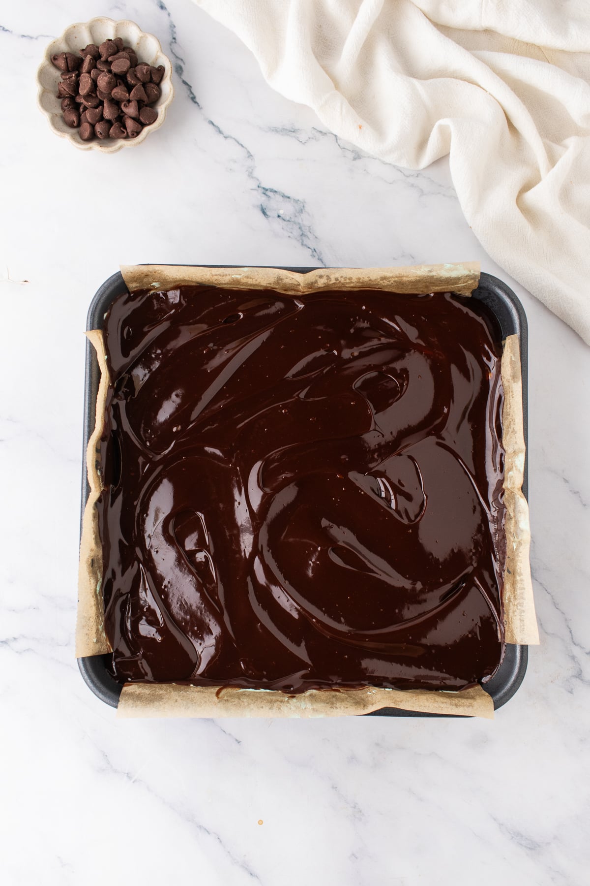 Chocolate ganache spread over the chilled green mint frosting