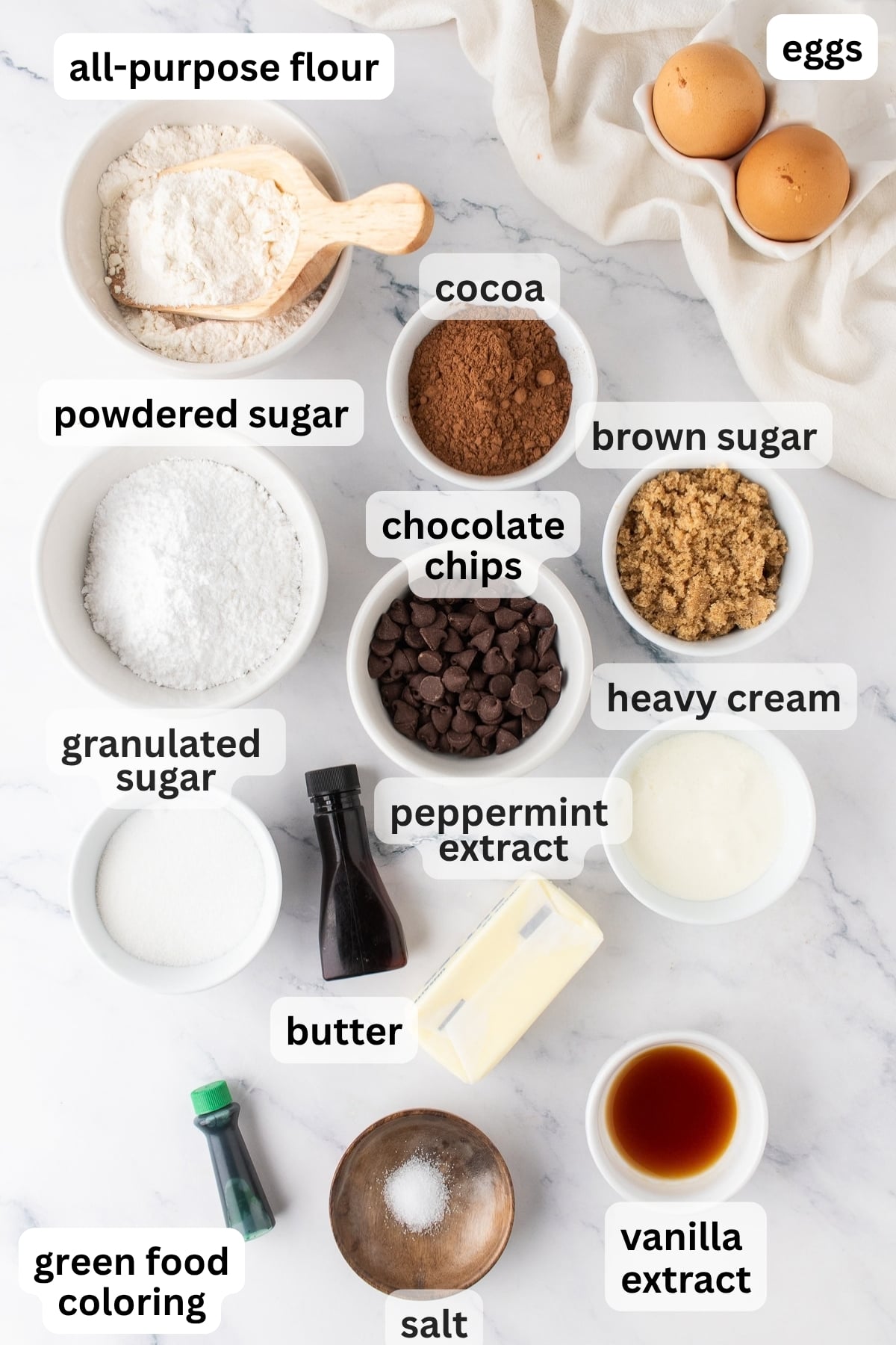 All of the ingredients needed to make Chocolate Mint Brownies in bowls on a table.
