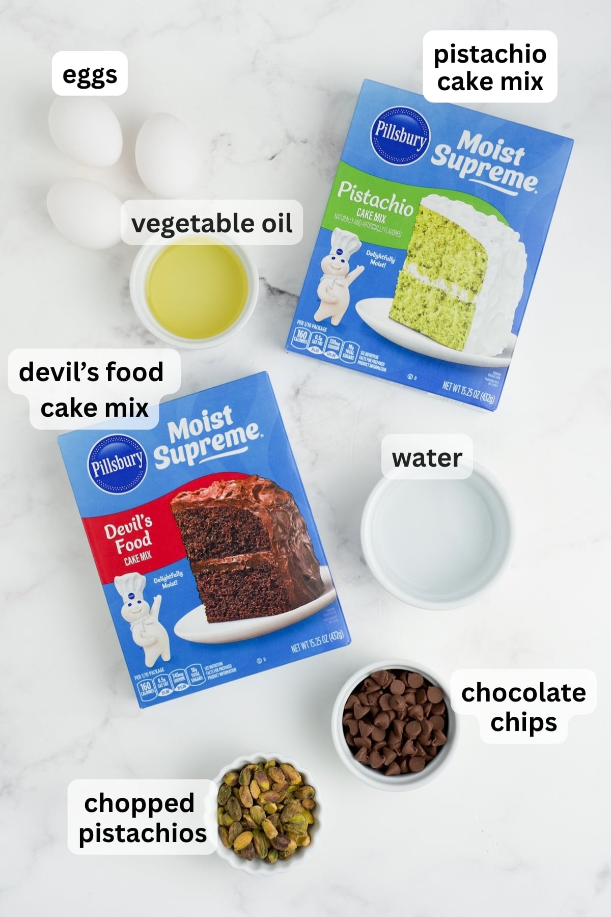 All of the ingredients needed to make Chocolate Pistachio Loaf in bowls and boxes on a counter.