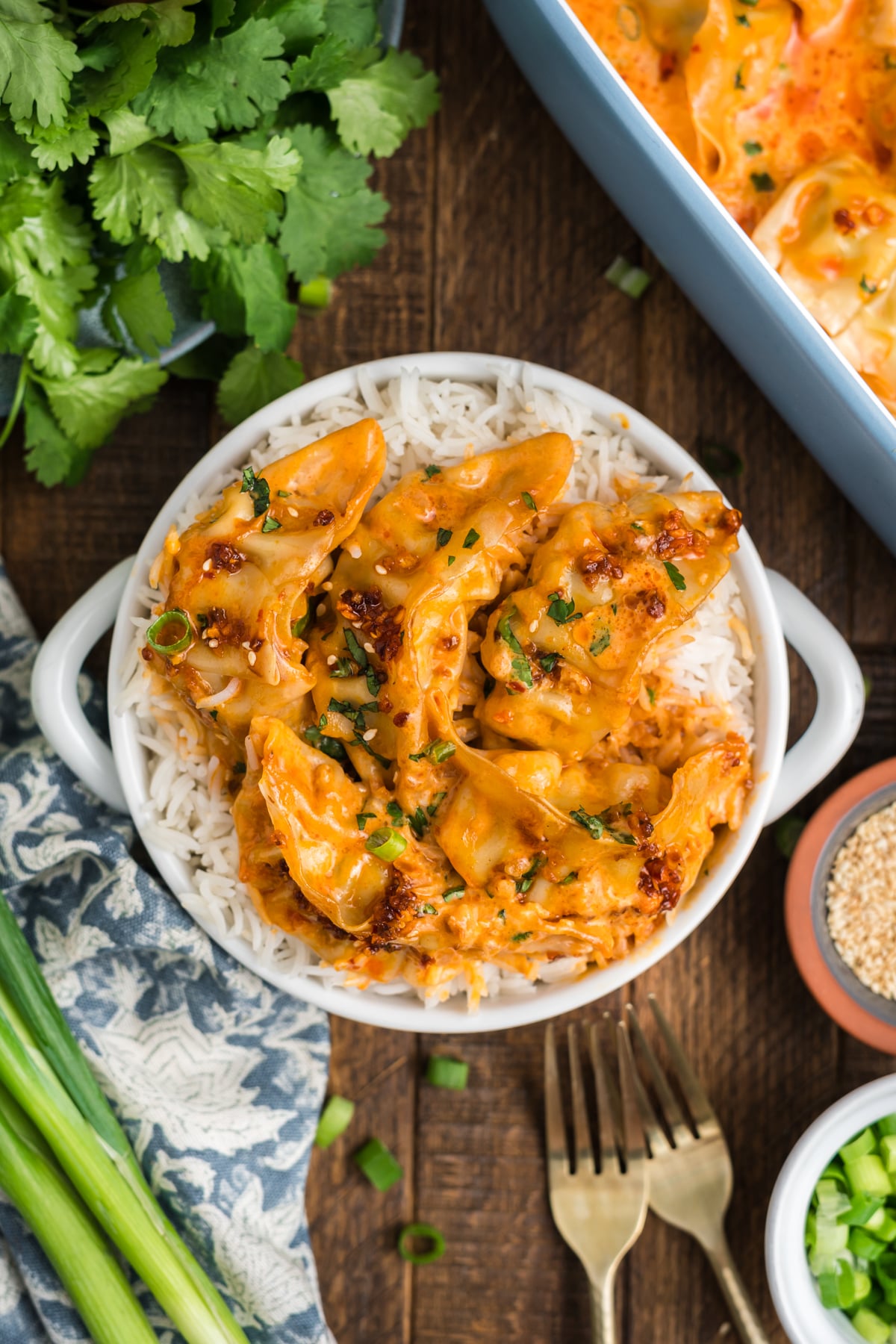 A bowl full of rice covered in dumplings and sauce.