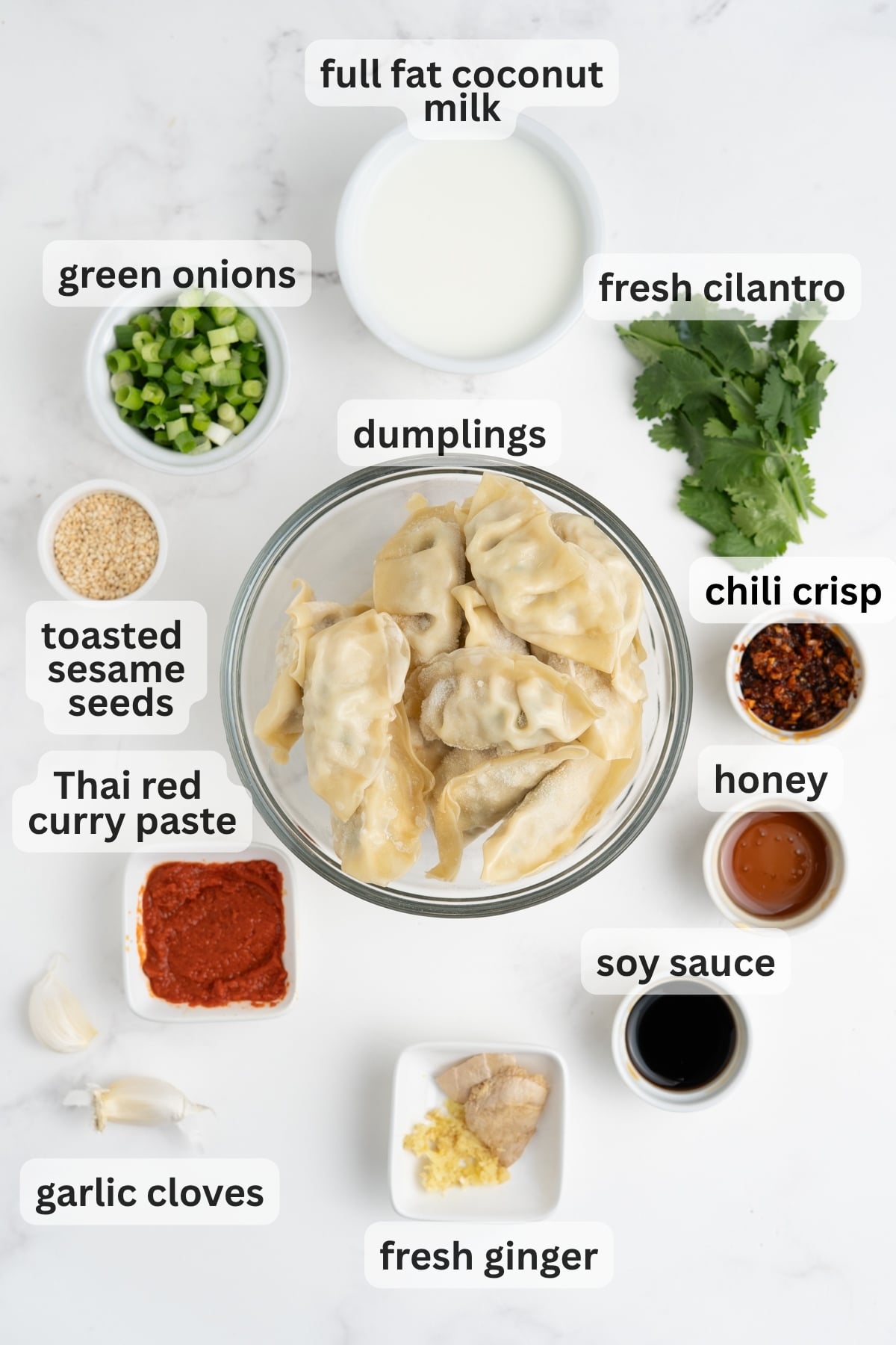 All of the ingredients needed to make a dumpling bake in bowls on a table.