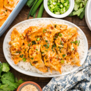A serving of dumpling bake on a rice covered plate ready to eat.