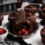 Easy cupcakes for Halloween (Vampire cupcakes) on a table with one broken open showing the cherries inside.