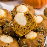 Starbucks pumpkin cream cheese muffins recipe on a plate with top one cut in half.