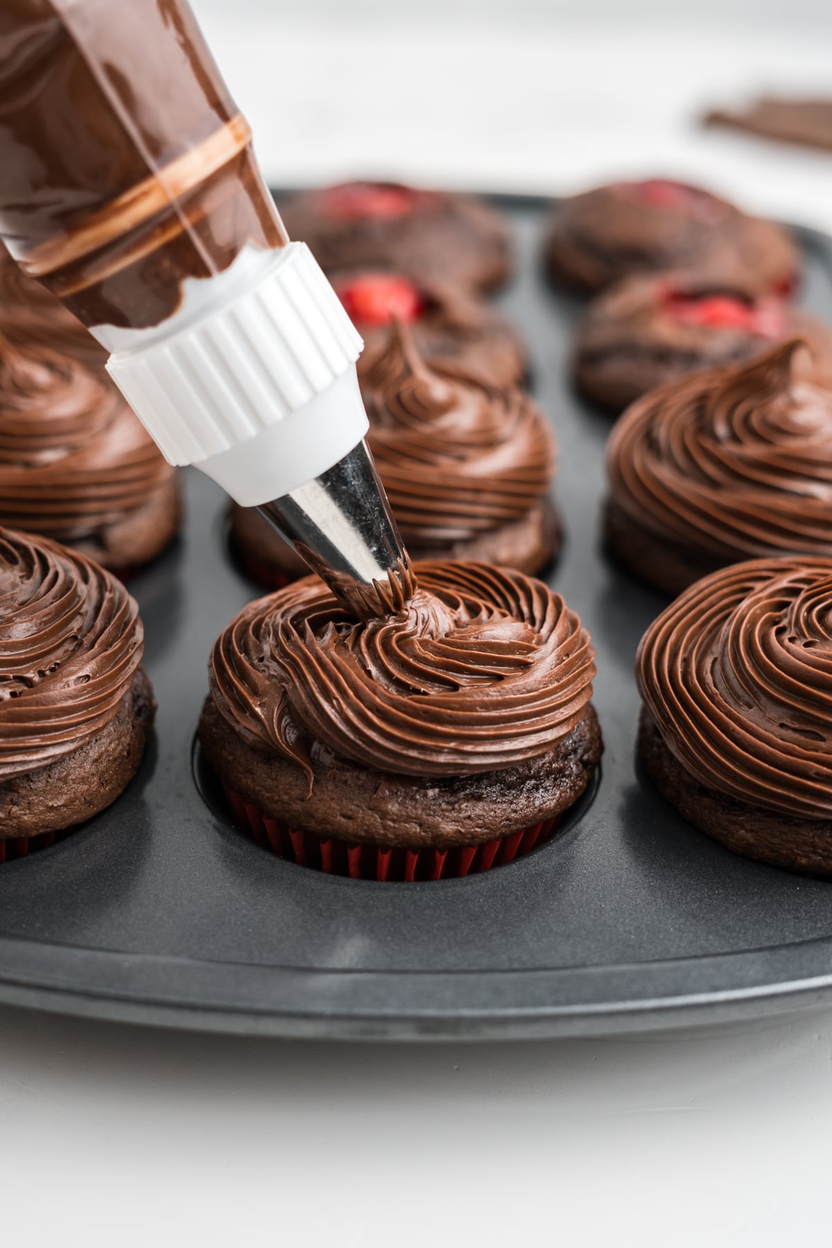 Frosting piped on top of cupcakes.
