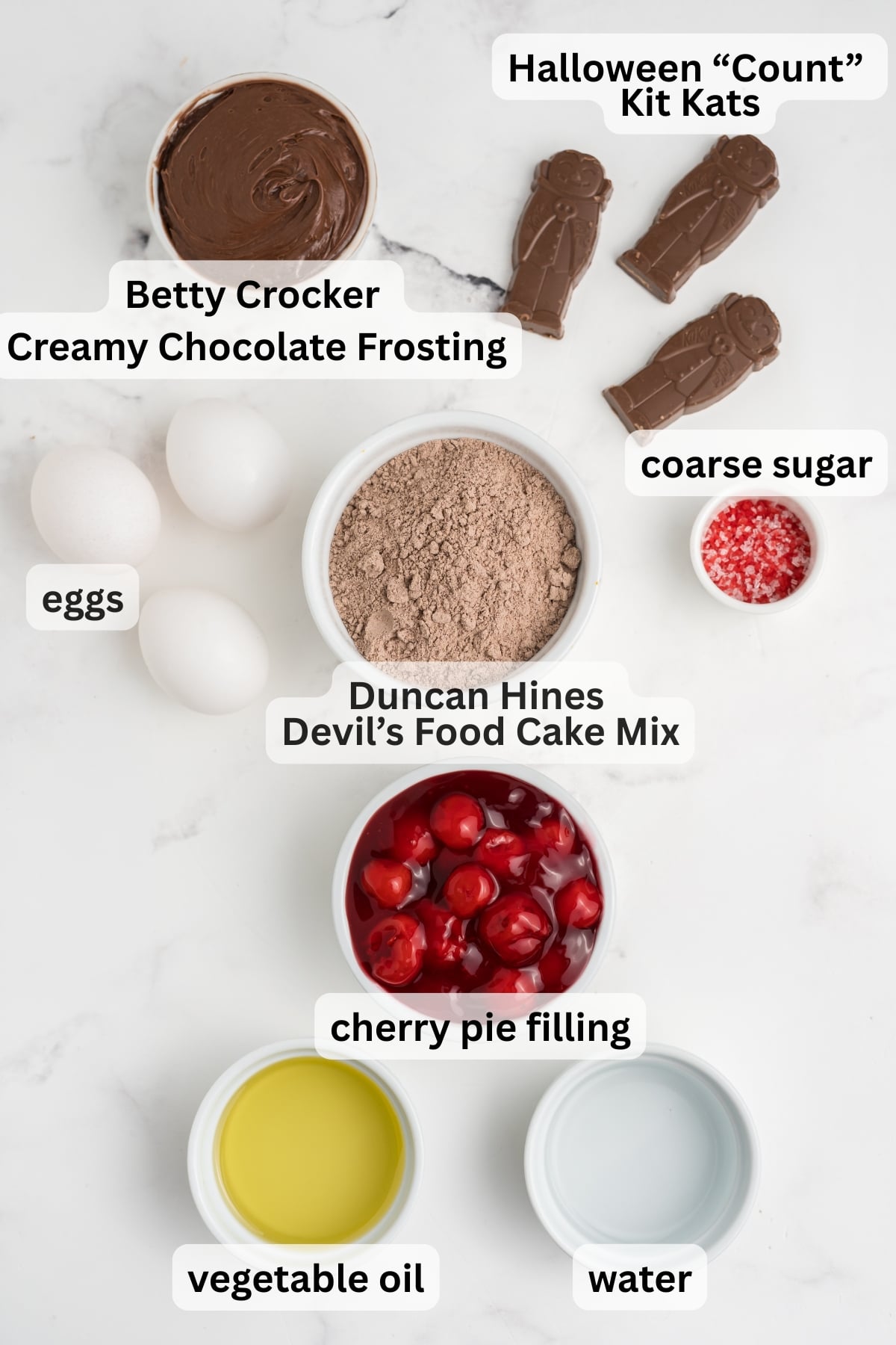 All of the ingredients needed to make easy cupcakes for Halloween in bowls on a table.