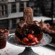 Easy cupcakes for Halloween on a table with one broken open showing the cherries inside.