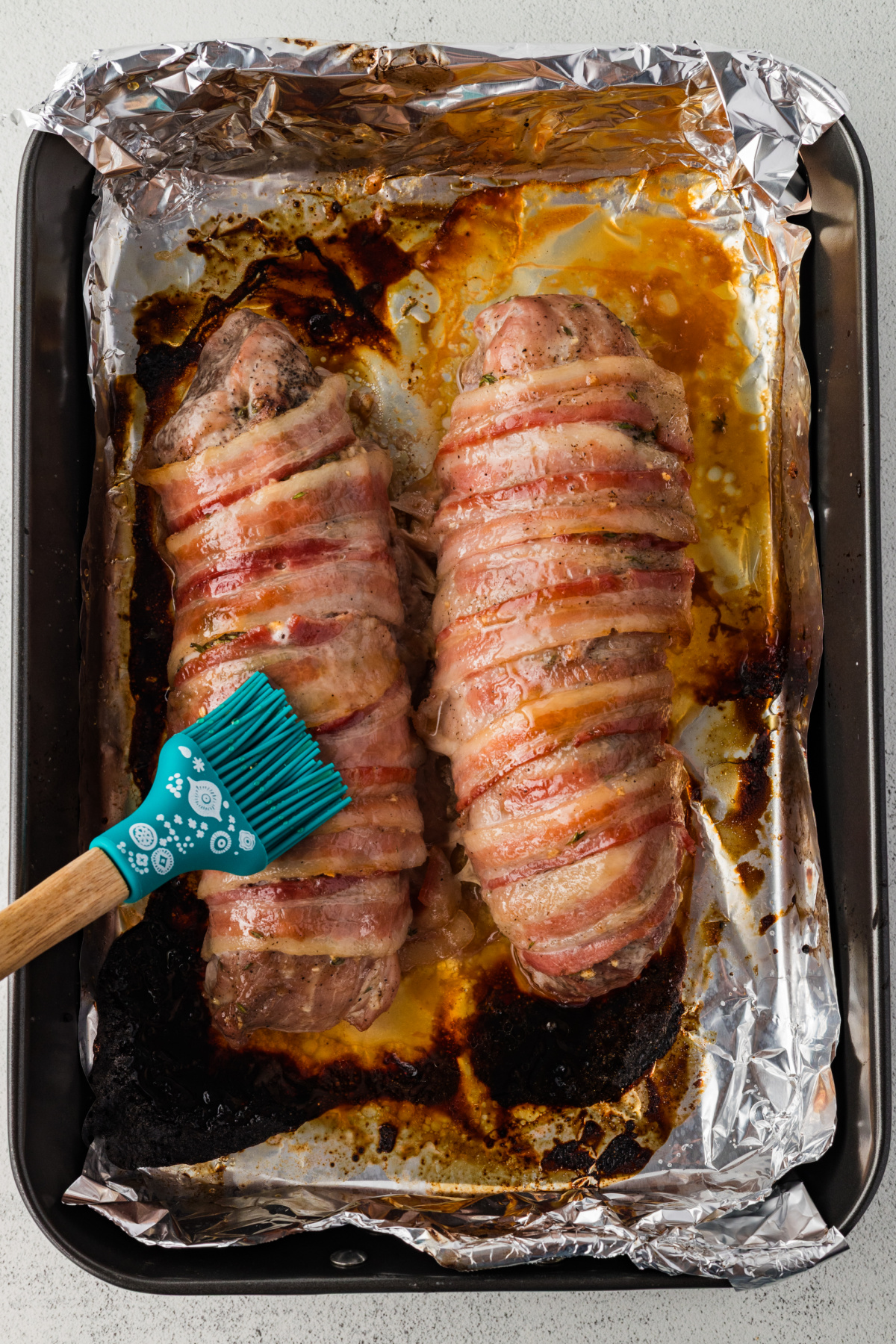 Maple syrup mixture being brushed on bacon.
