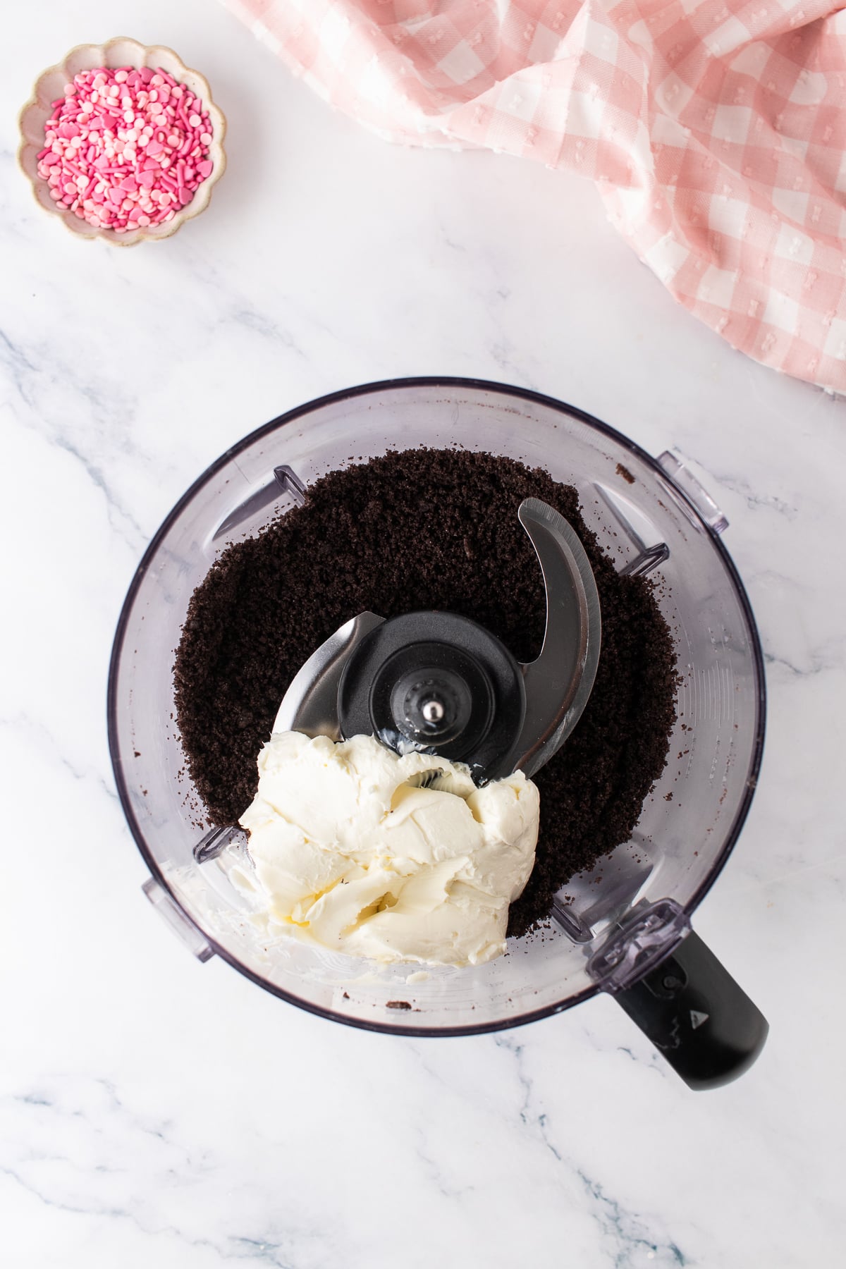 Oreo cookies, softened cream cheese, and vanilla in a food processor.