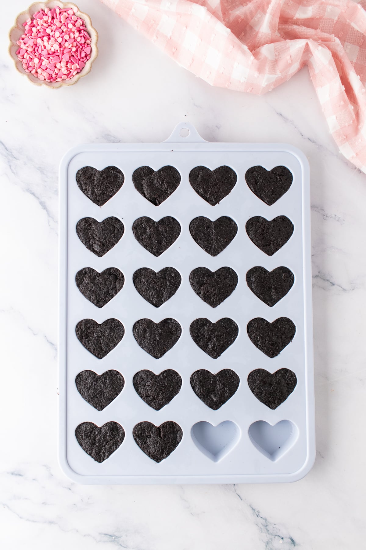 Oreo and cream cheese mixture pressed into a silicone heart mold.