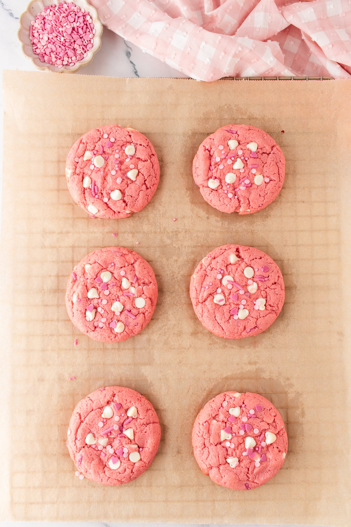 Baked cookies cooling on parchment covered baking sheet.