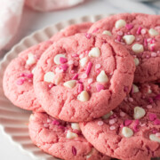 A pile of pink velvet cookies on a serving plate.