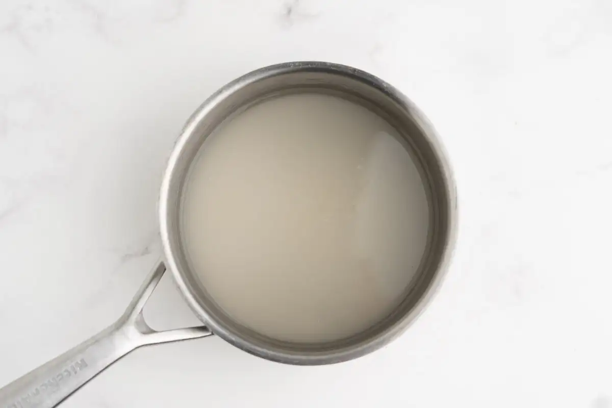 Sugar and water combined in a saucepan.