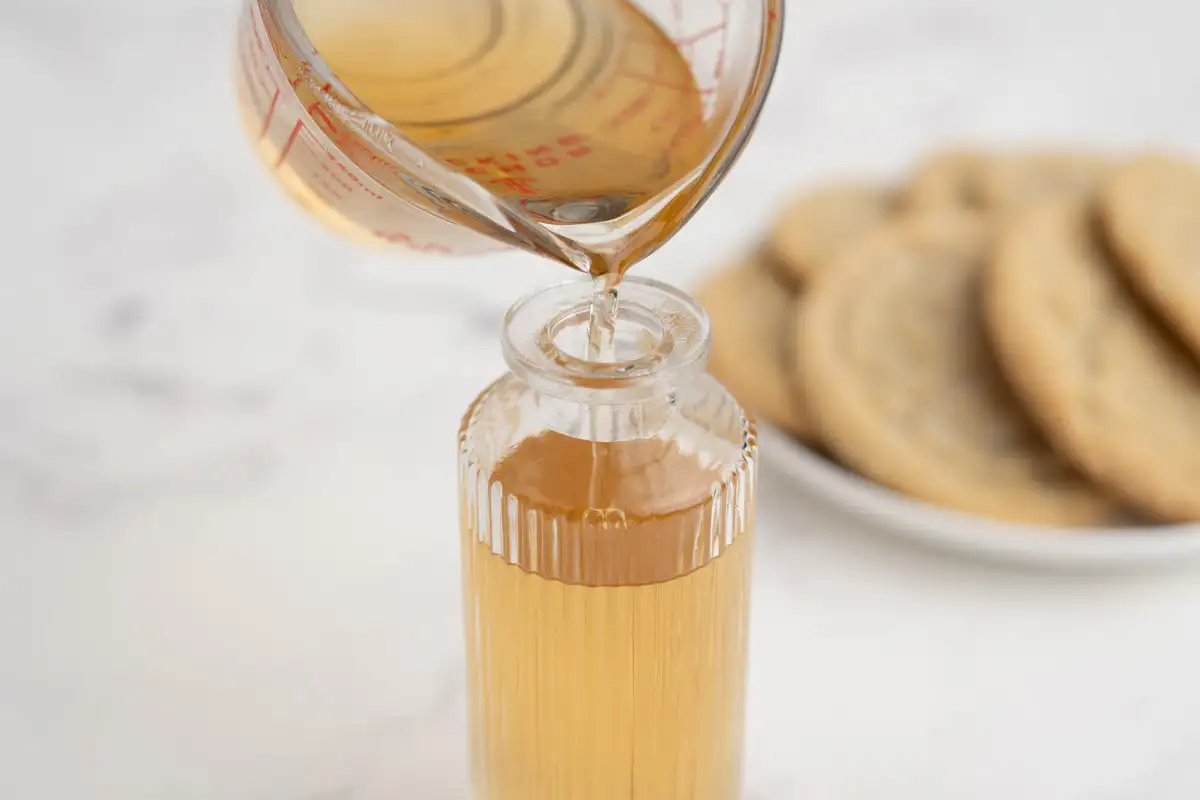 Finished sugar cookie syrup poured into a glass bottle.