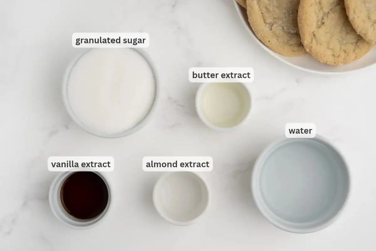 The ingredients needed to make Starbucks sugar cookie syrup in bowls on a table.