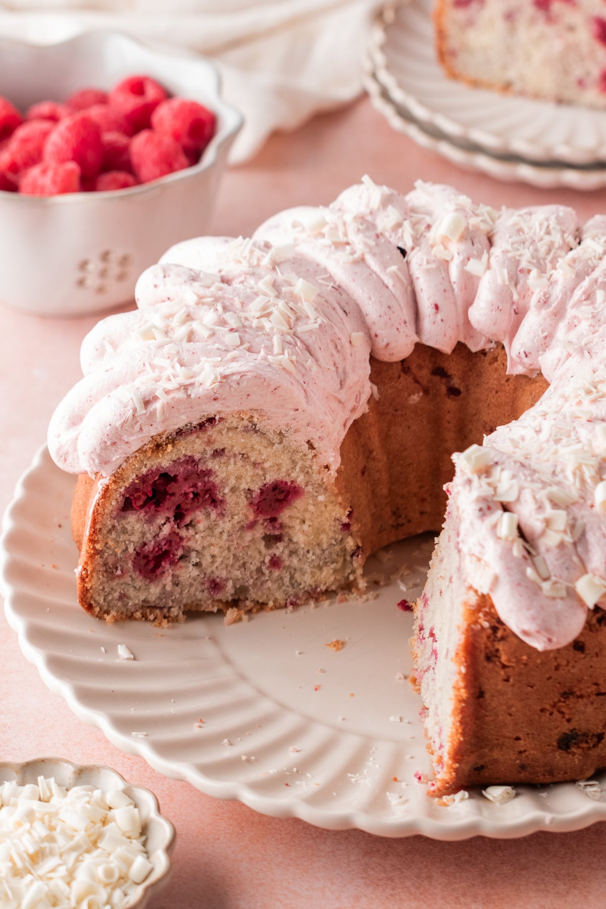 Bundt cake on a plate with a few slices missing.