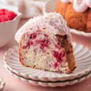 A slice of white chocolate raspberry cake on a plate.