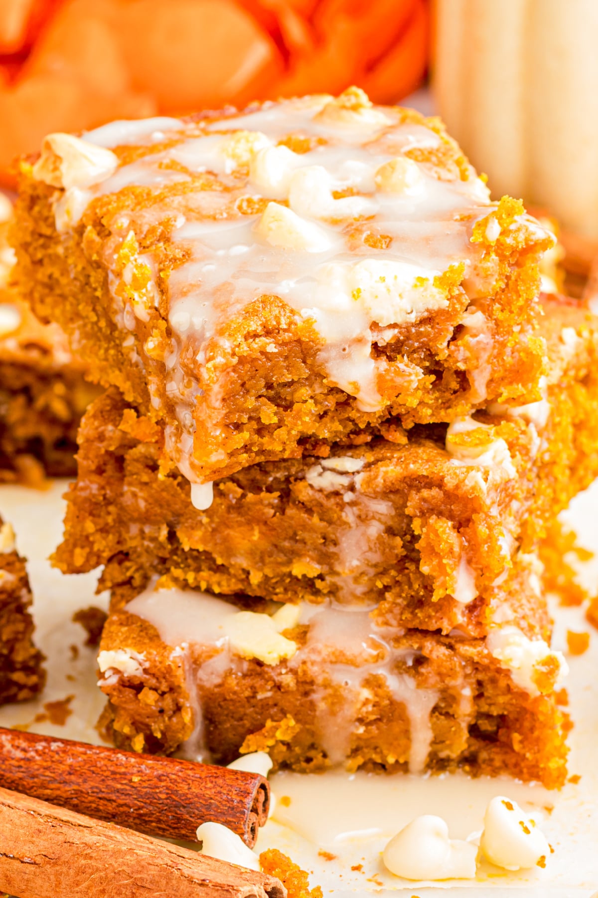 A stack of blondies on a platter with the top one glazed.