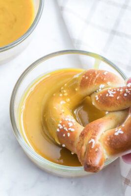 A home made pretzel dipped in honey mustard sauce.