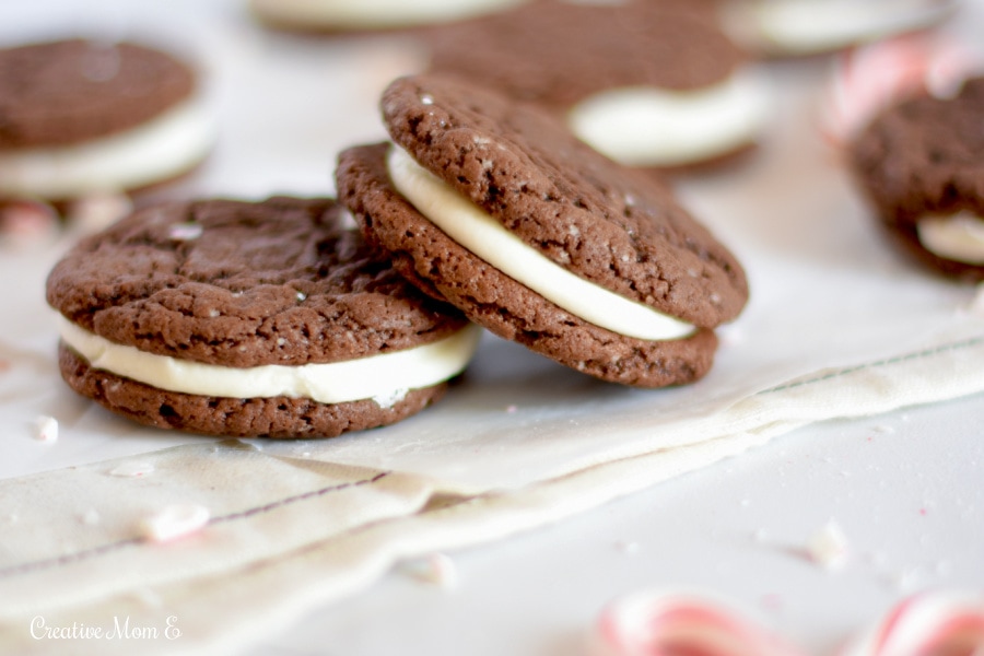 Close up of chocolate cookies with crushed candy canes next to them.