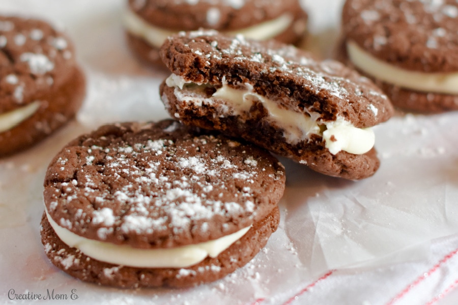 Chocolate Fudge Sandwich Cookies with a bite taken out of one.