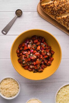 Overhead photo of Tomato Bruschetta in a yellow-colored bowl.